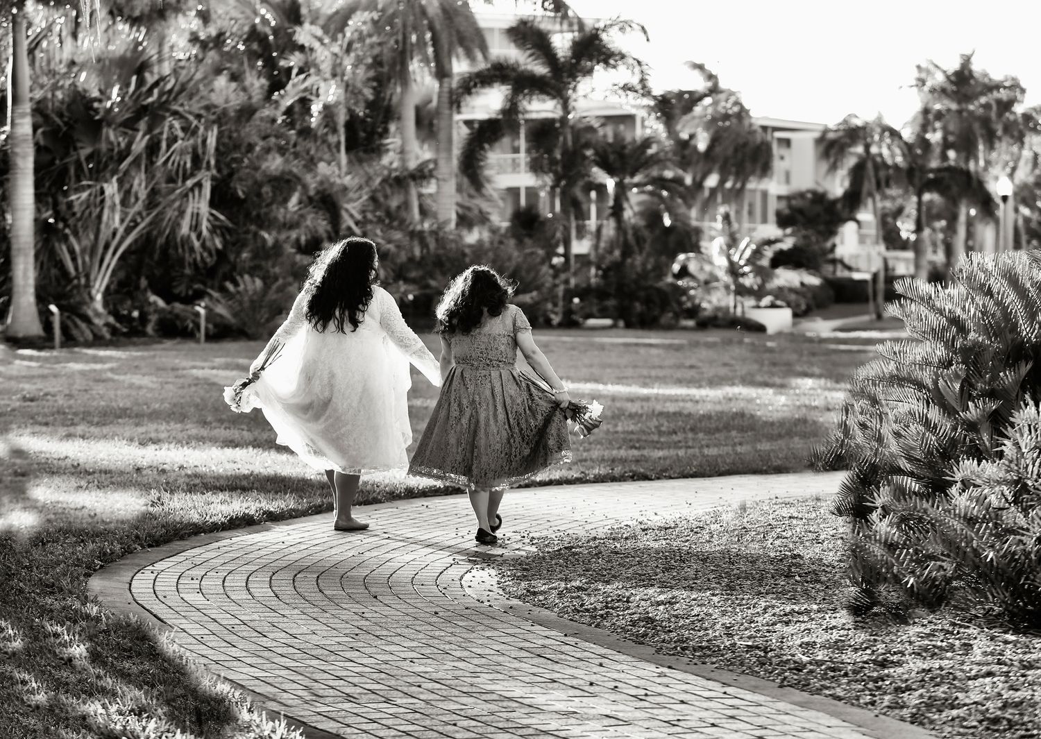 two women just married, holding hands walking through park in st petersburg, fl