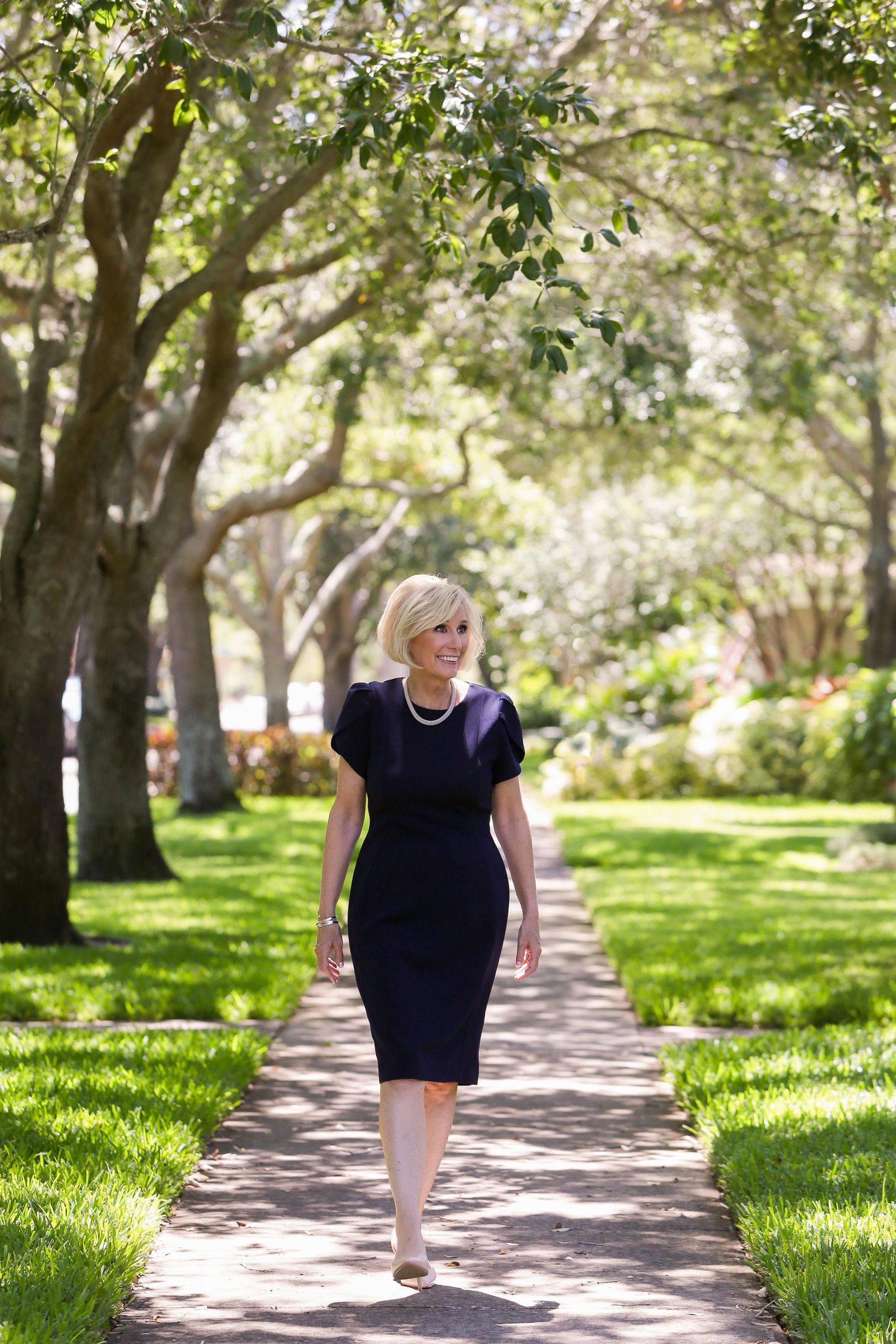 Executive woman walking on sidewalk in Old Northeast St. Petersburg FL