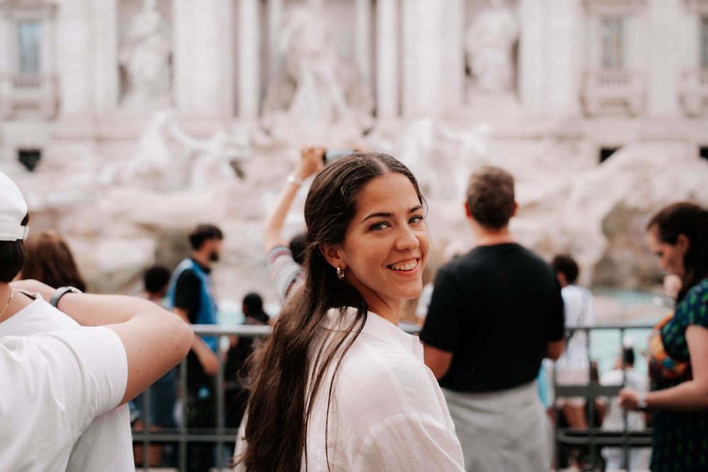 Girl in front of Fontena De Trevi in Rome