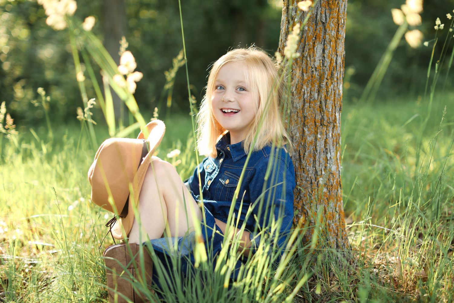 Natural outdoor portrait session in a sun-dappled forest setting.
