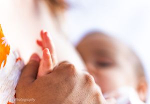 Close-up photo of hands reaching toward the sky in soft focus.