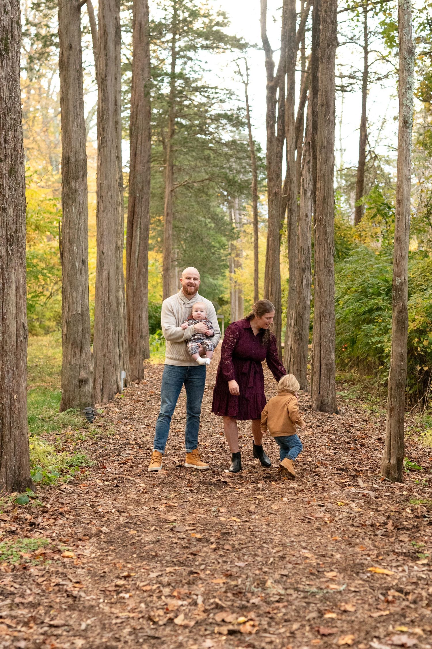 A large tree provides a backdrop for an outdoor portrait in warm evening light.