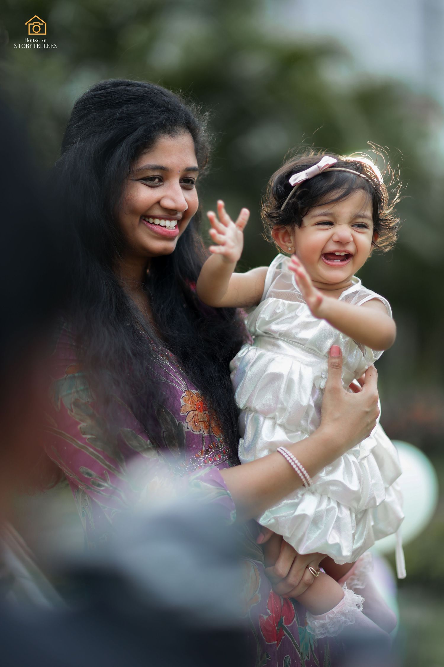 Joyful moment captured outdoors of two people sharing laughter and smiles.