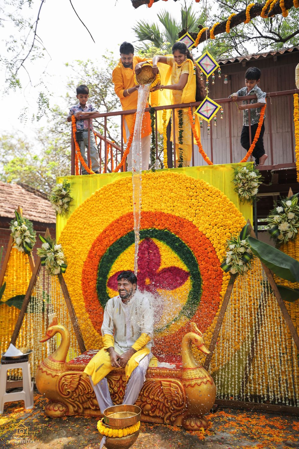 Elaborate floral decoration with yellow marigold backdrop featuring ornate design and seating arrangement.