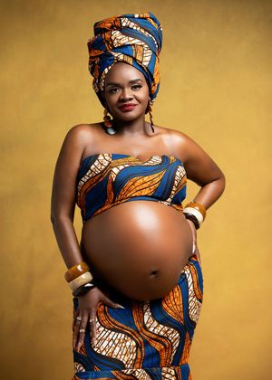 Maternity photo series showing a pregnant woman in blue and orange African print dress against golden background.