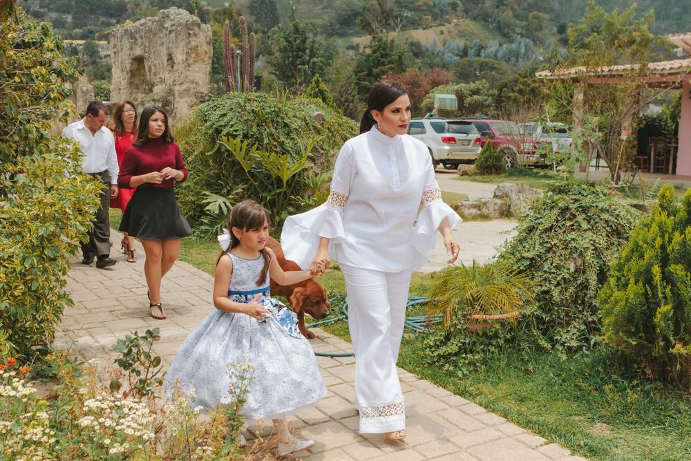 Family heading towards the baptism ceremony, capture by NYC family photographer Paula Ortiz