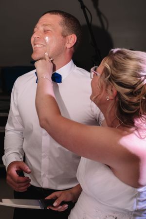 Candid moment of newlyweds laughing during wedding reception.