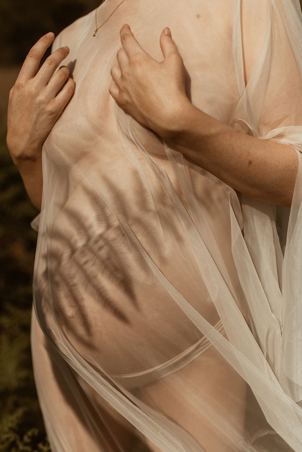 Artistic series of close-up shots showing abstract skin tones and flowing white fabric in beautiful soft lighting.