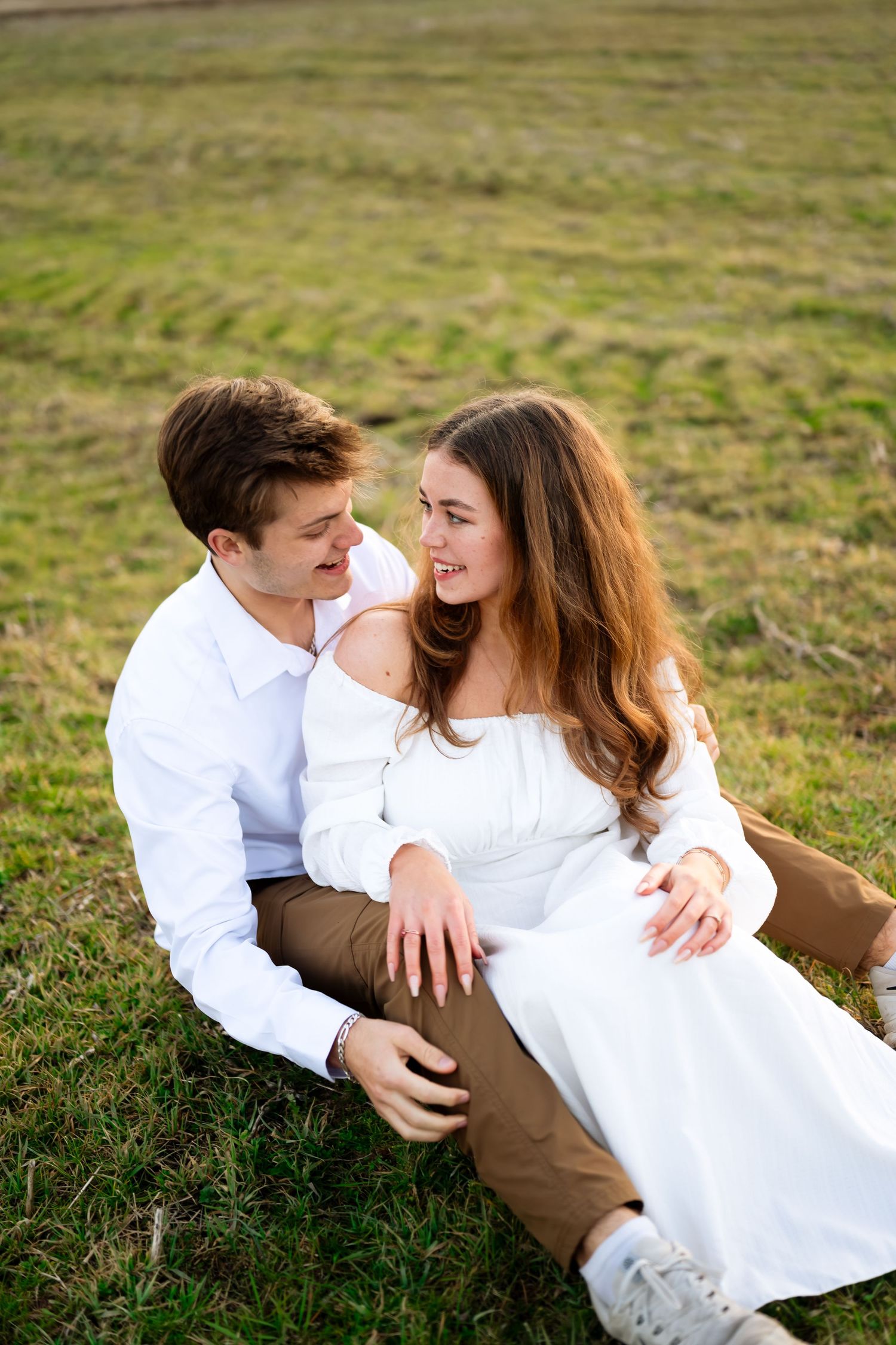 Black and white portrait of couple sitting together outdoors.