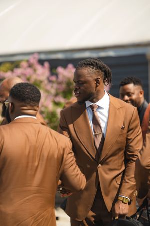 candid portrait of a wedding day. groomsmen getting ready for the shoot