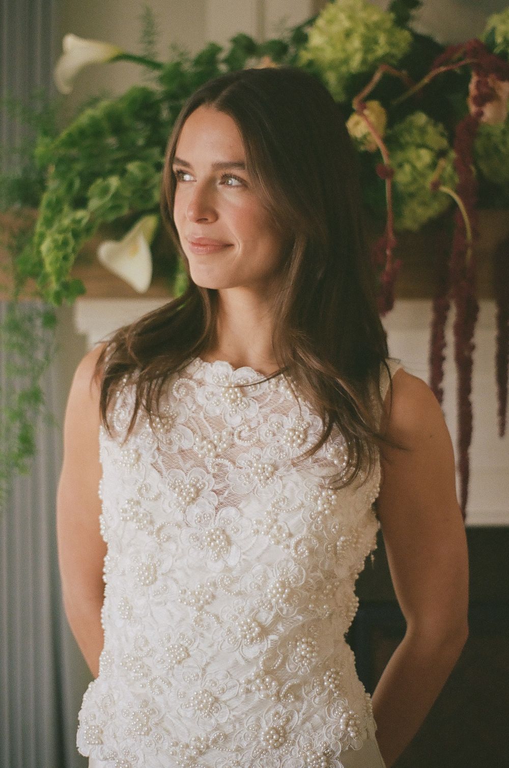 A series of photos showing someone in a delicate white lace wedding dress with intricate floral details.