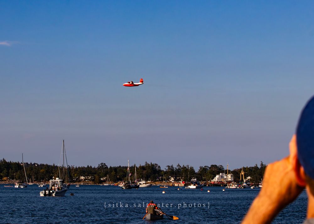 Hawaii Mars soars above harbour filled with boats on a clear day.
