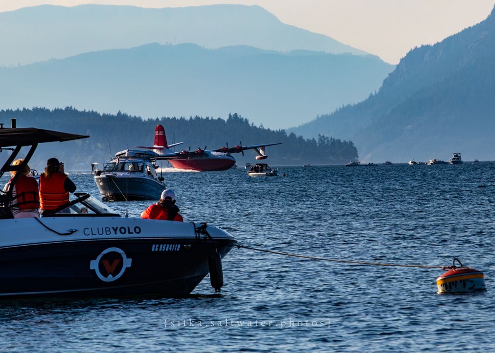 Hawaii Mars water landing among boats with layered mountain silhouettes behind.