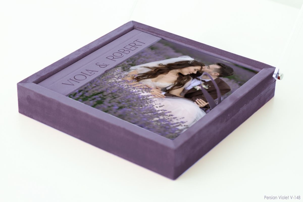 Purple leather wedding album with romantic couple photo on cover.