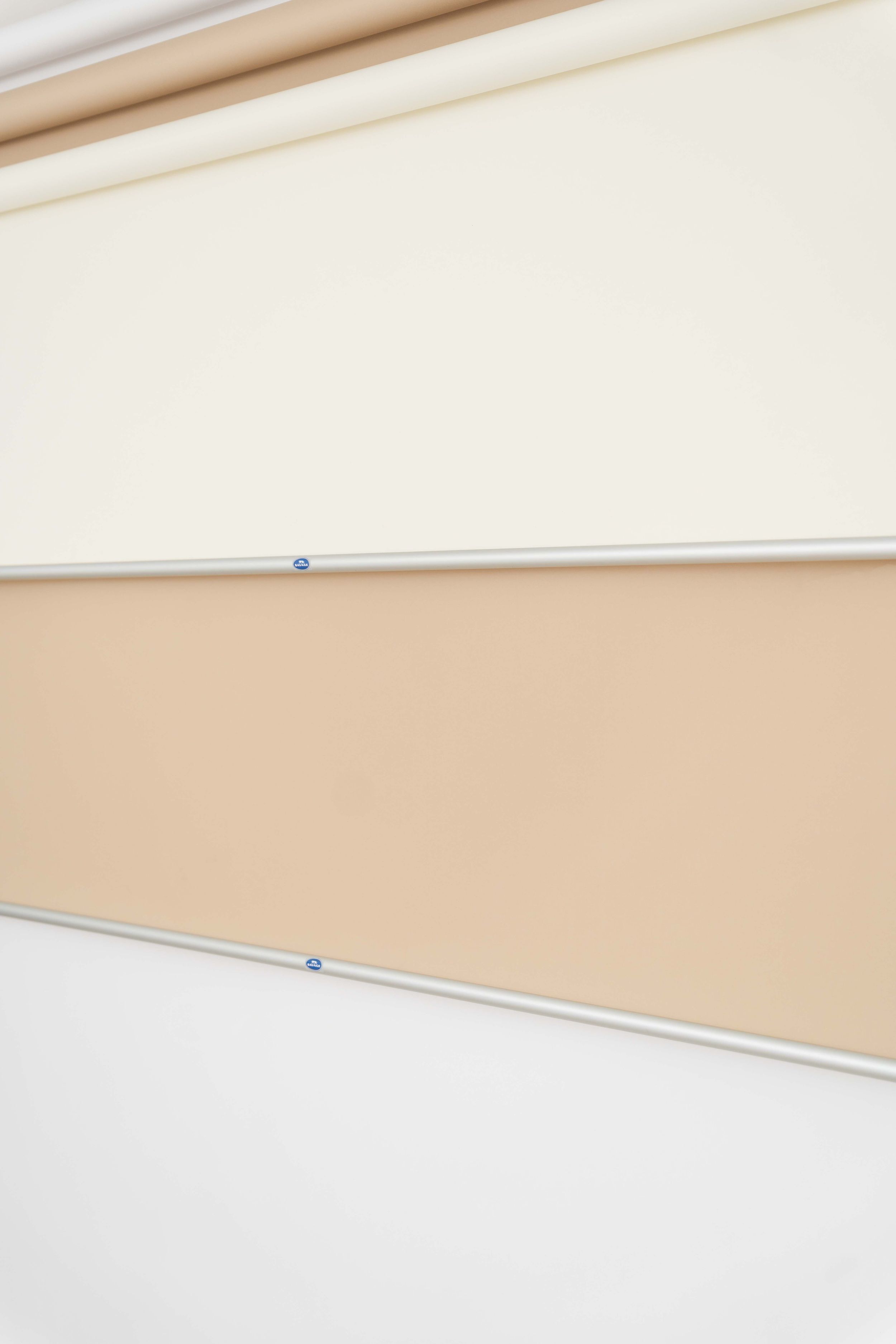 Abstract architectural detail showing diagonal lines of white and beige surfaces creating a minimalist geometric pattern.