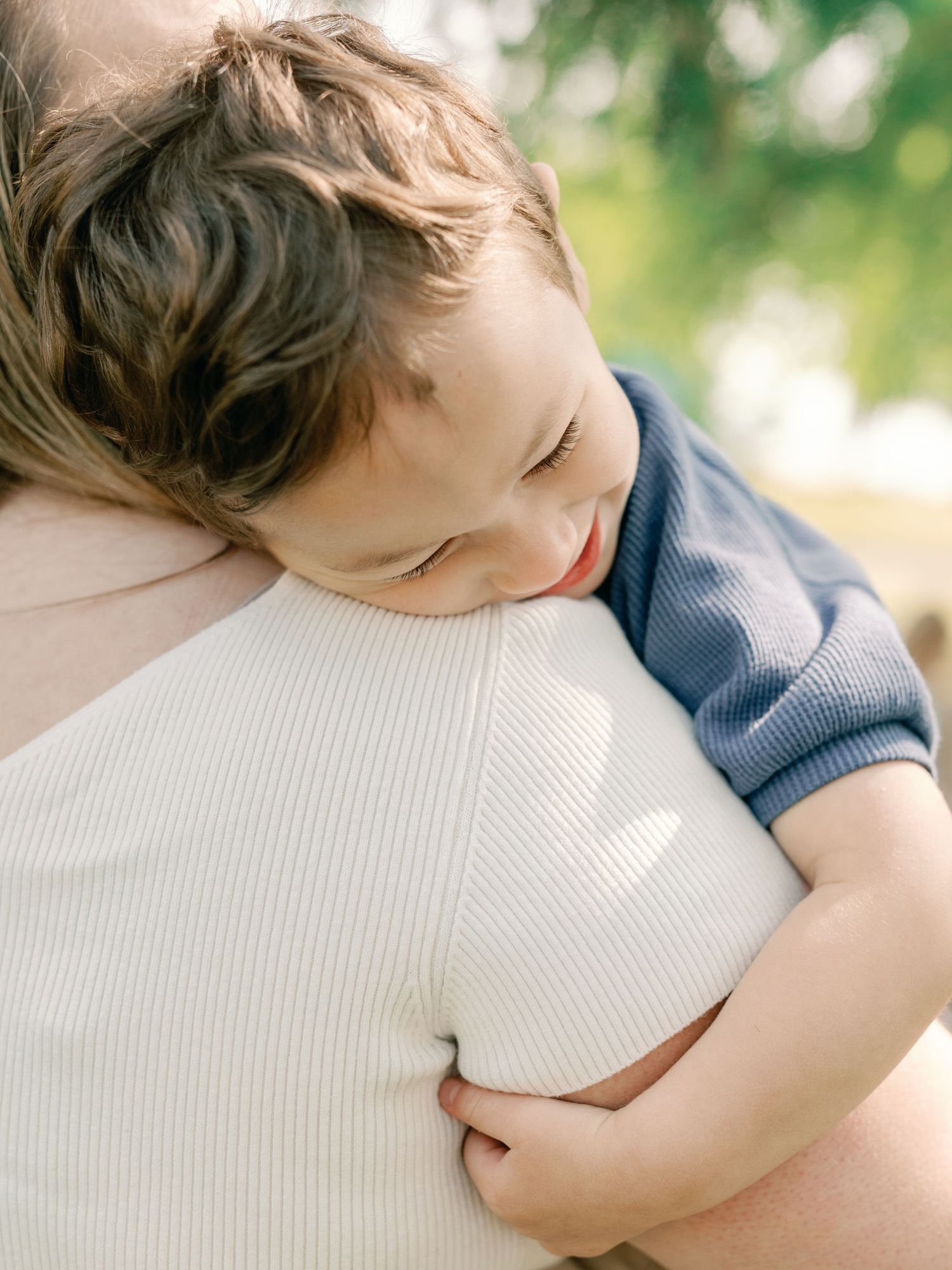 Close-up sequence of a sleeping child resting peacefully on a white textured surface.