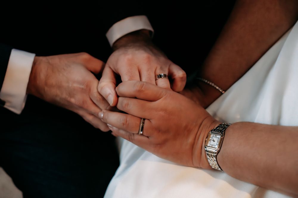 Close-up shots showing hands exchanging wedding rings during a marriage ceremony.