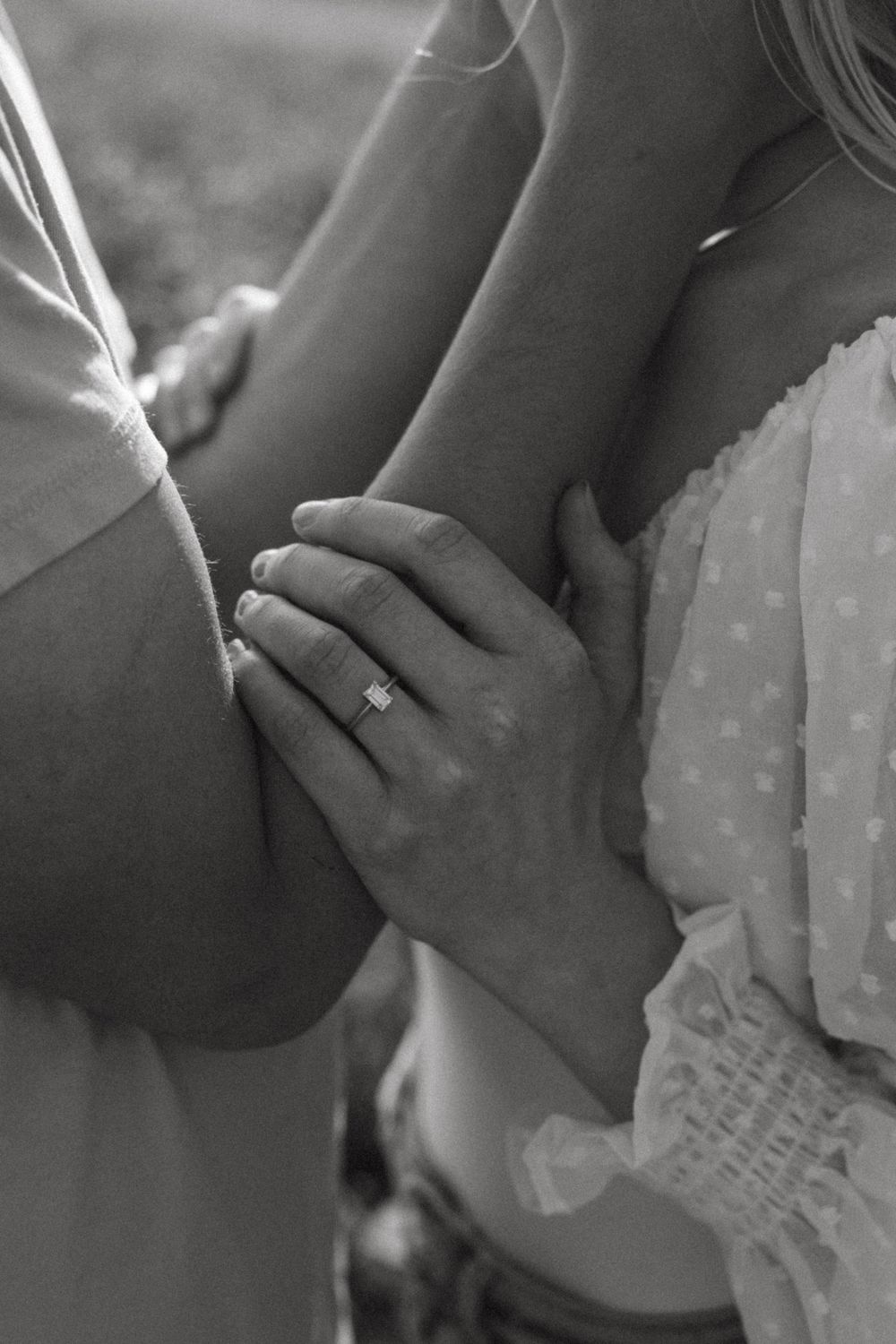 Intimate black and white close-up of a couple's tender embrace.
