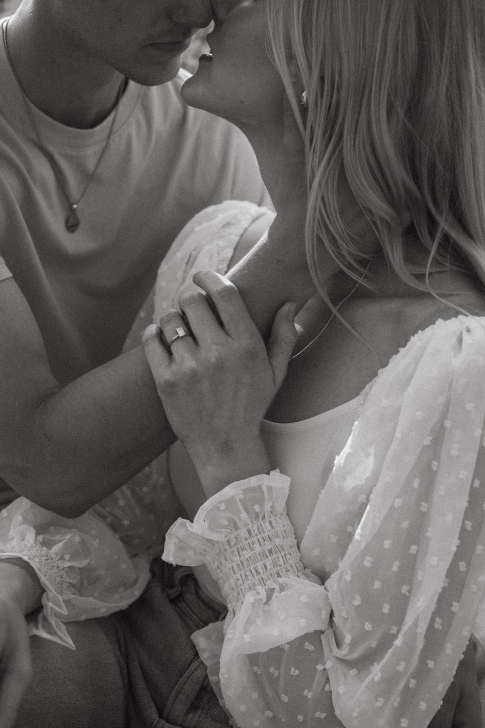 Black and white close-up shots of an intimate romantic moment.