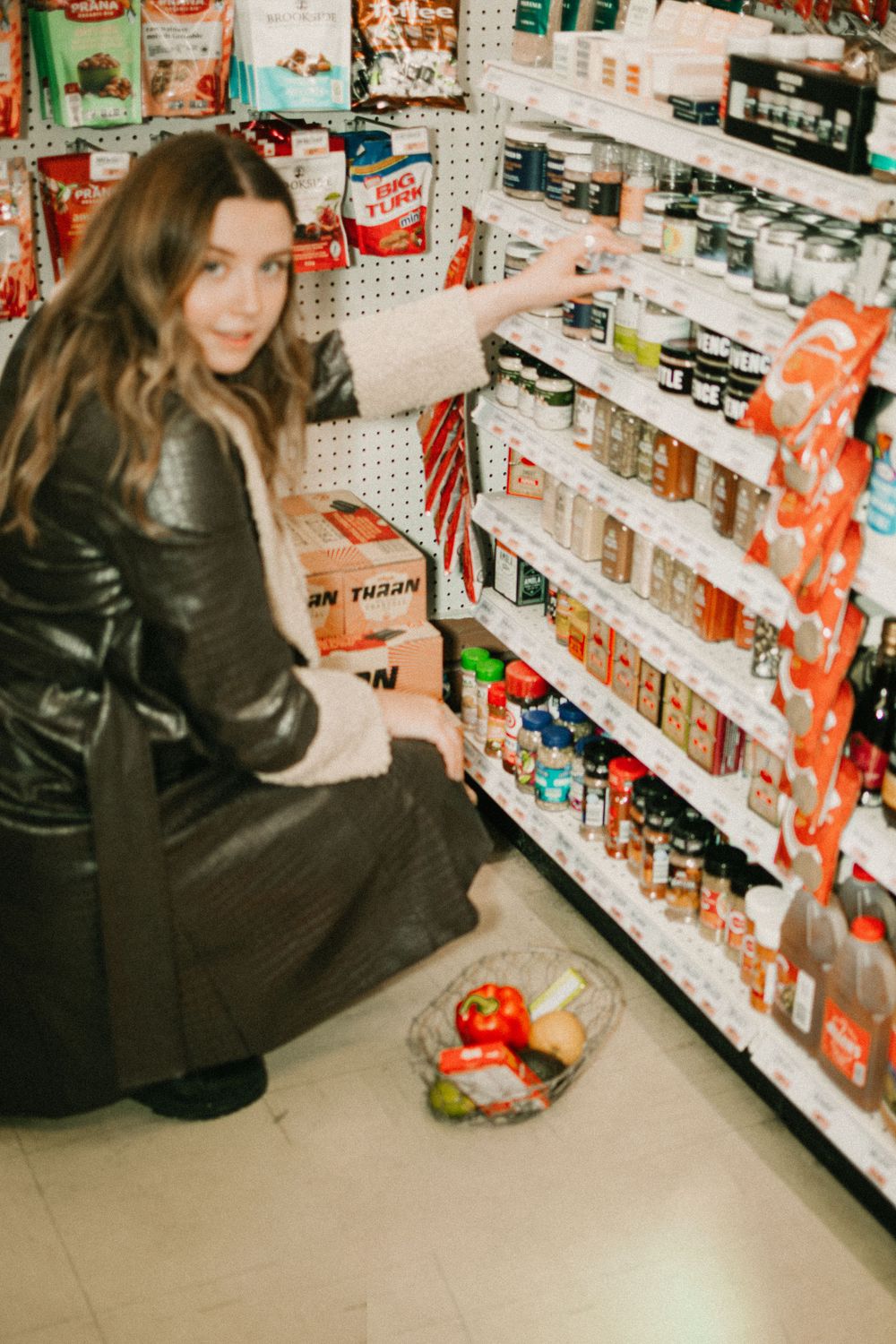 Shopping aisle with organized shelves of food products and groceries.