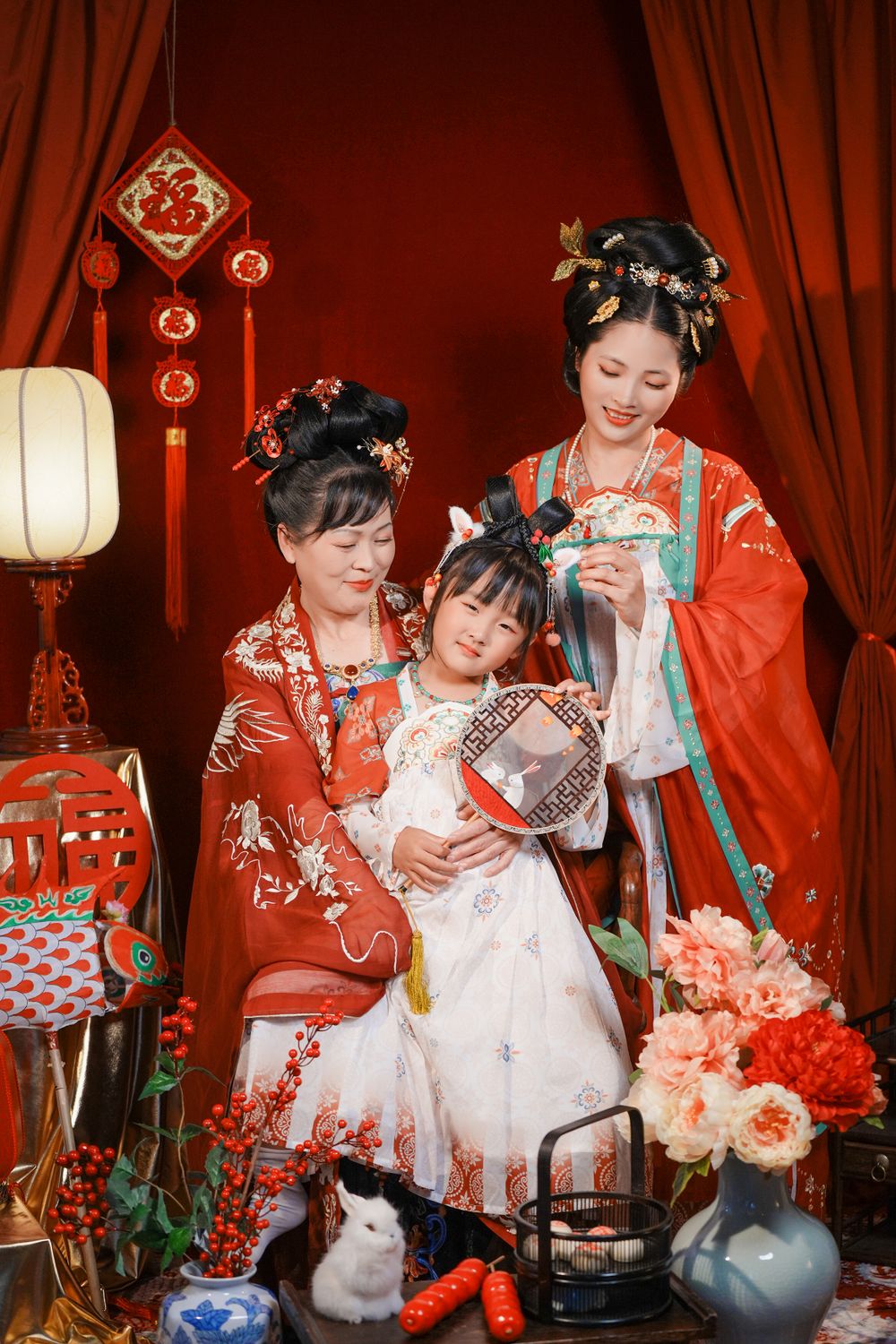 Cinematic warm-toned Tang Dynasty Hanfu portrait of a 3-generation family celebrating Lunar New Year, by Imagine Image Studio Auckland.