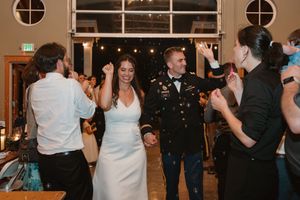 Wedding guests dancing in pairs during an evening reception.