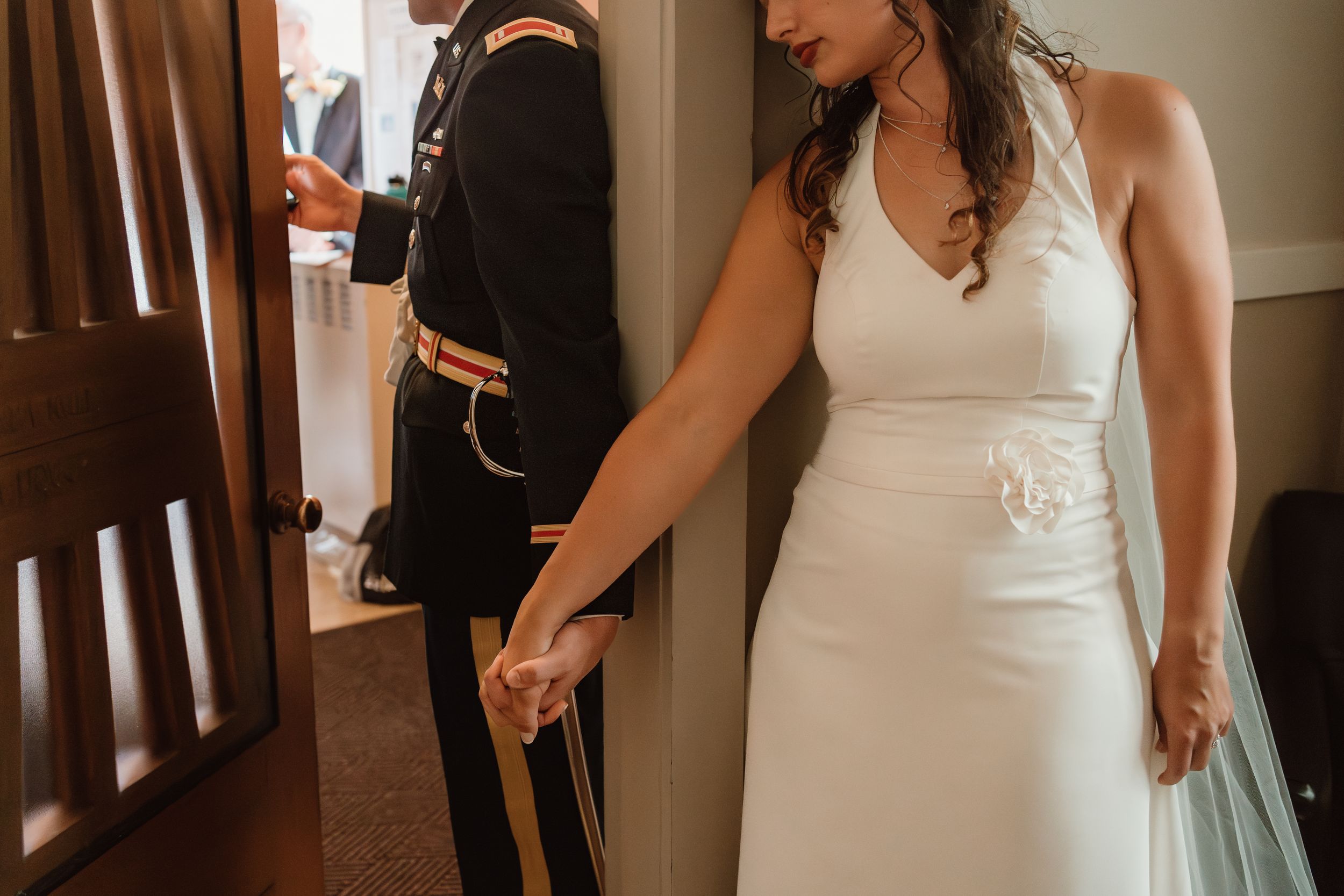 Wedding dress details shown in an indoor setting with natural lighting.