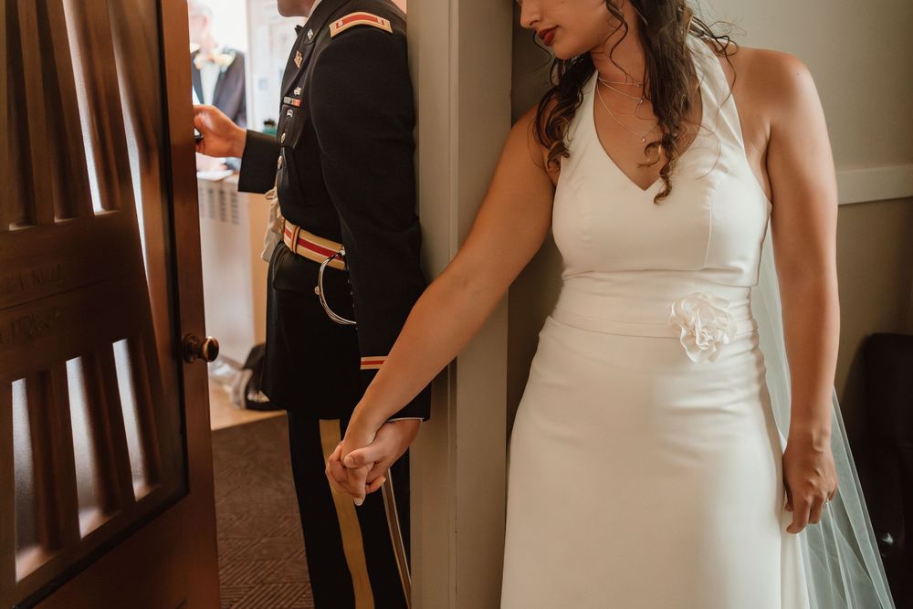 Wedding dress details shown in an indoor setting with natural lighting.