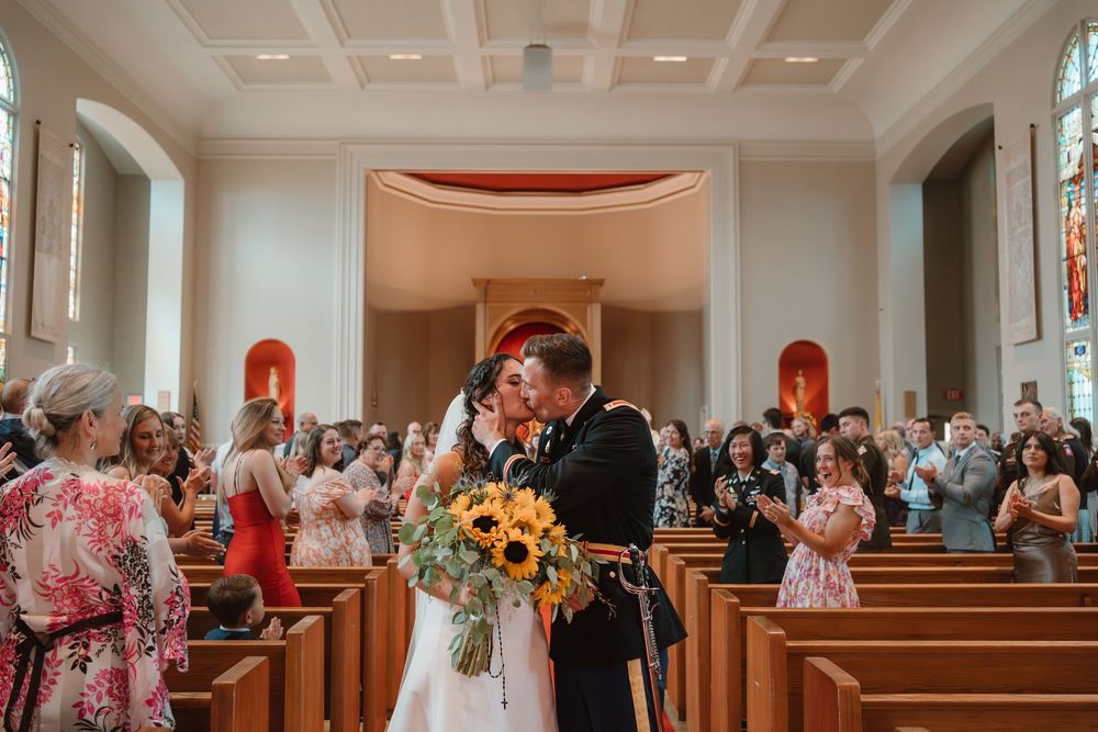 Wedding guests seated in church pews during ceremony.