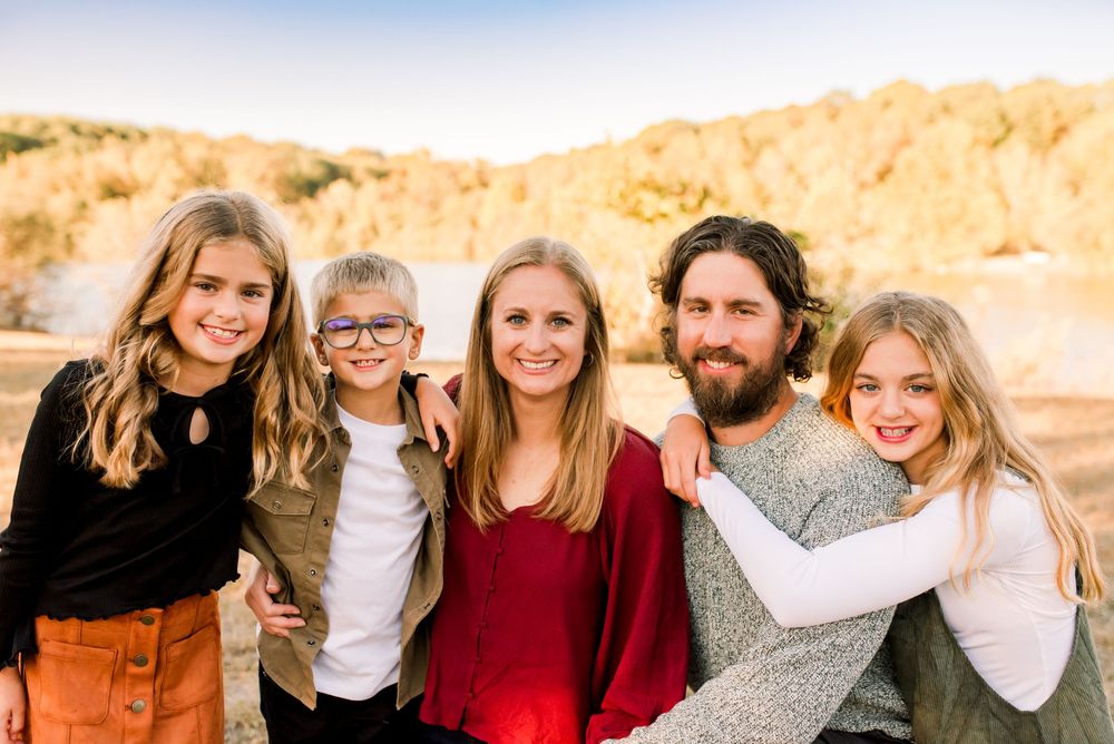 A series of family portraits taken outdoors against a golden desert landscape at sunset.