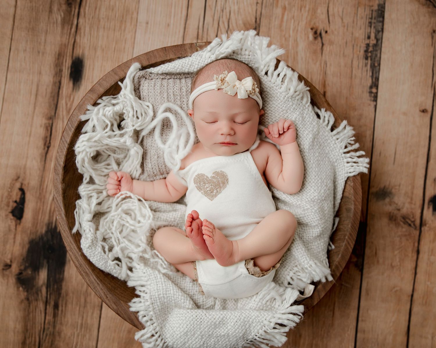 Sleeping newborn wearing knit hat on textured background.