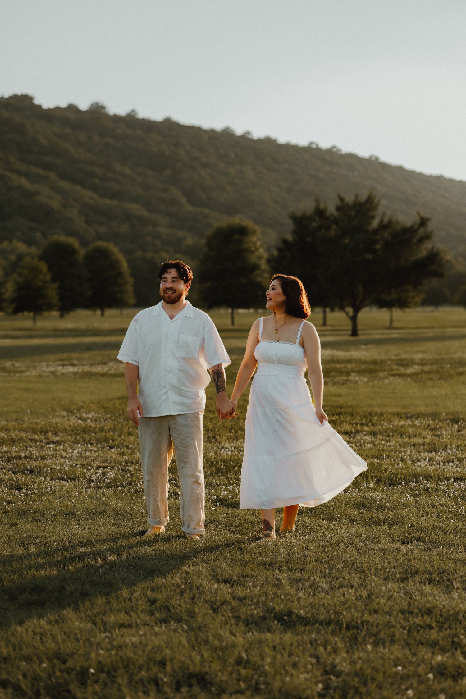 Couple holding hands by a mountain
