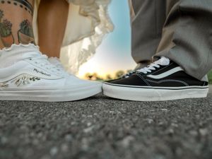 A collage of shoes shown from ground level perspective, featuring various sneakers and footwear on textured surfaces.