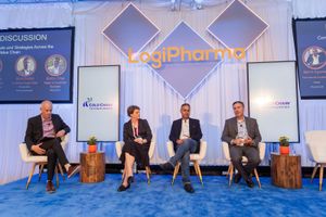 Panel discussion with four speakers seated on stage at LogiPharma conference event.