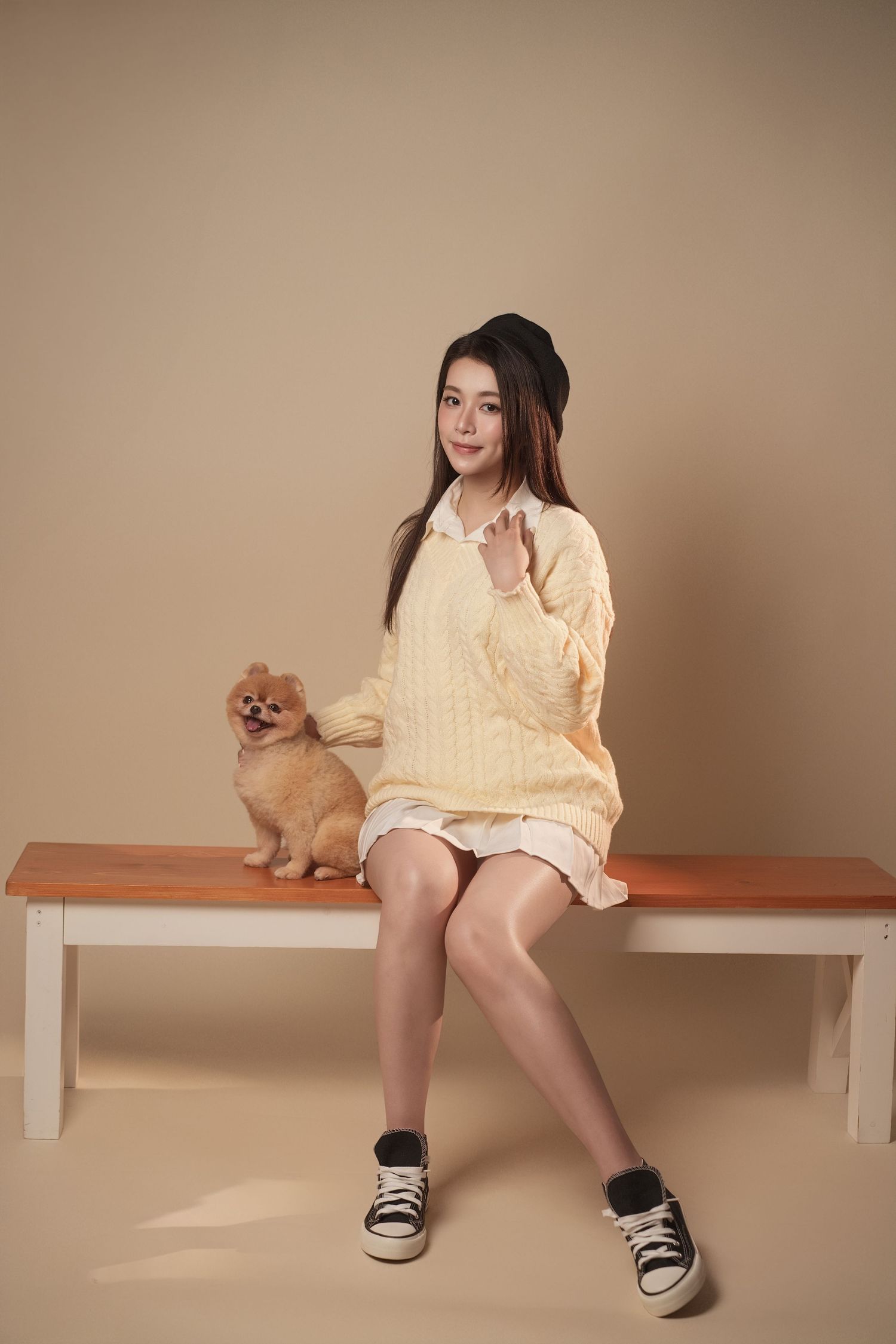 A sequence of images showing someone in a light yellow dress sitting on a wooden bench with a small Pomeranian dog.