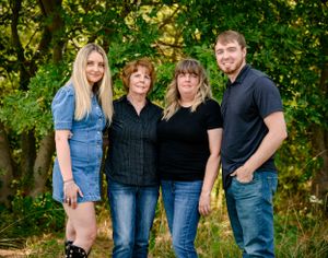 Lovely family posing in an open field in the summer.