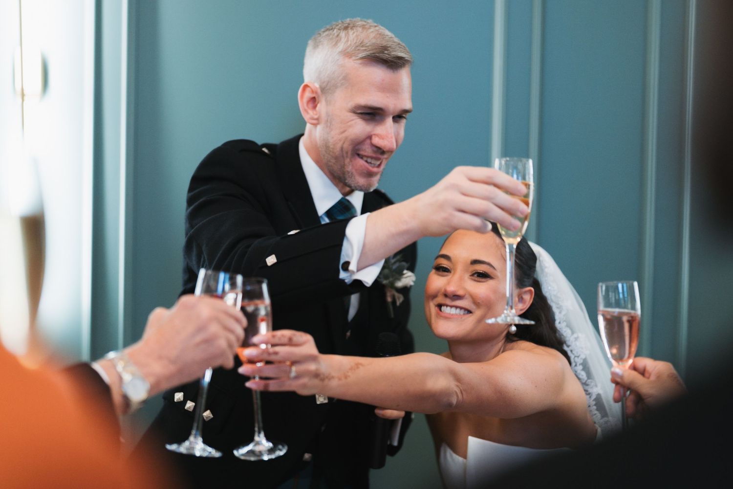 Emotional wedding ceremony moment during vow reading in an elegant reception hall.