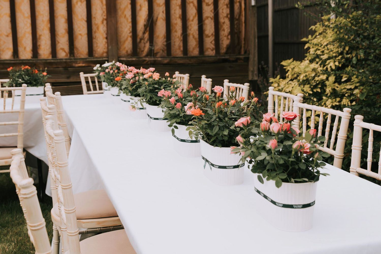 Table setting details with flower vases during birthday event