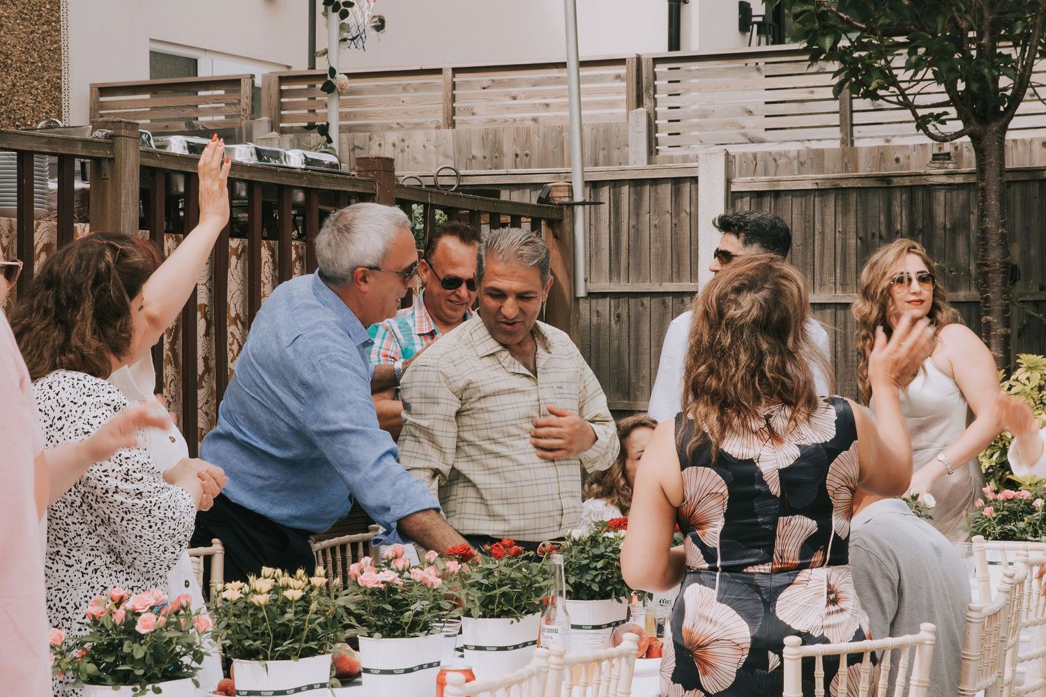 Guests welcoming each other at an outdoor birthday event