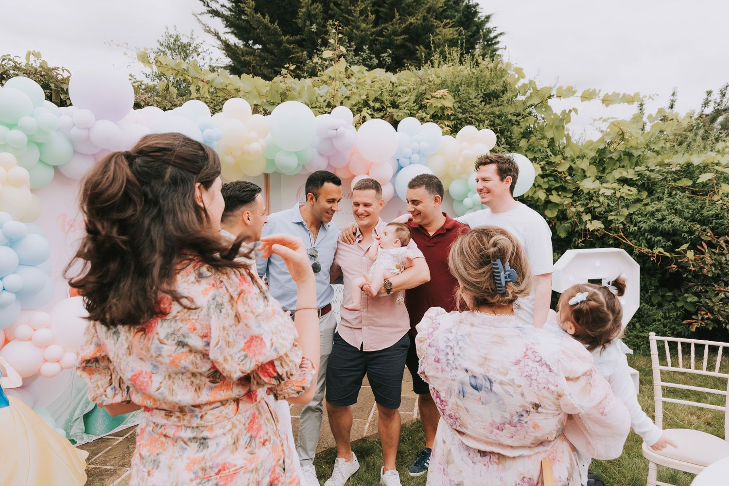 Guests mingling at an outdoor birthday event enjoying conversation and vibes