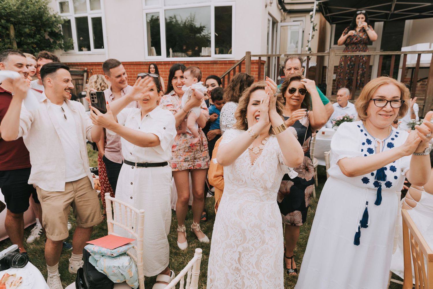 Guests cheering at an outdoor birthday event enjoying birthday party vibes