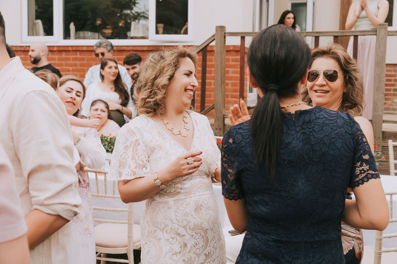 Guests dancing at an outdoor birthday event enjoying conversation and vibes