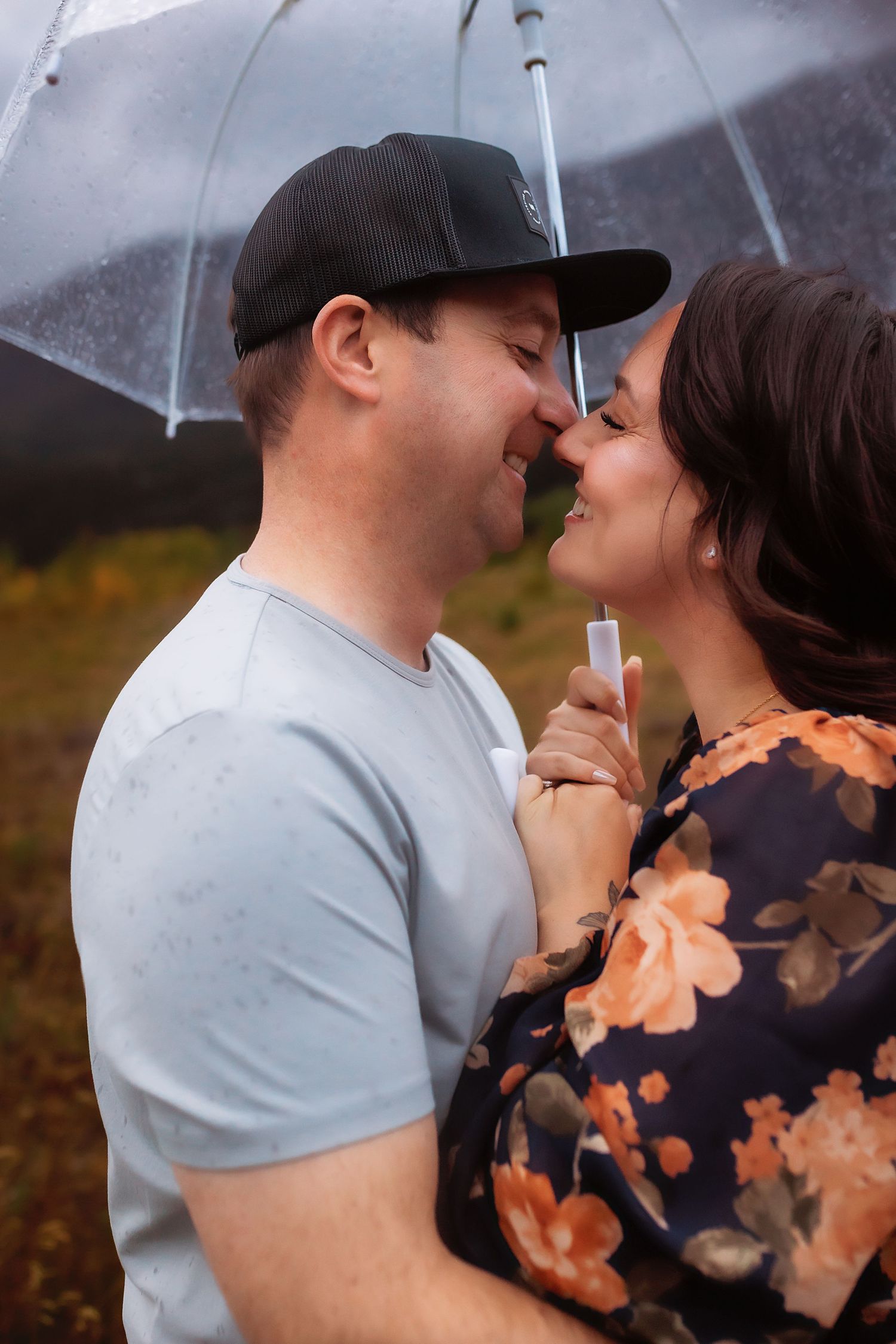 Intimate sunset moment between couple with warm backlighting and natural outdoor setting.