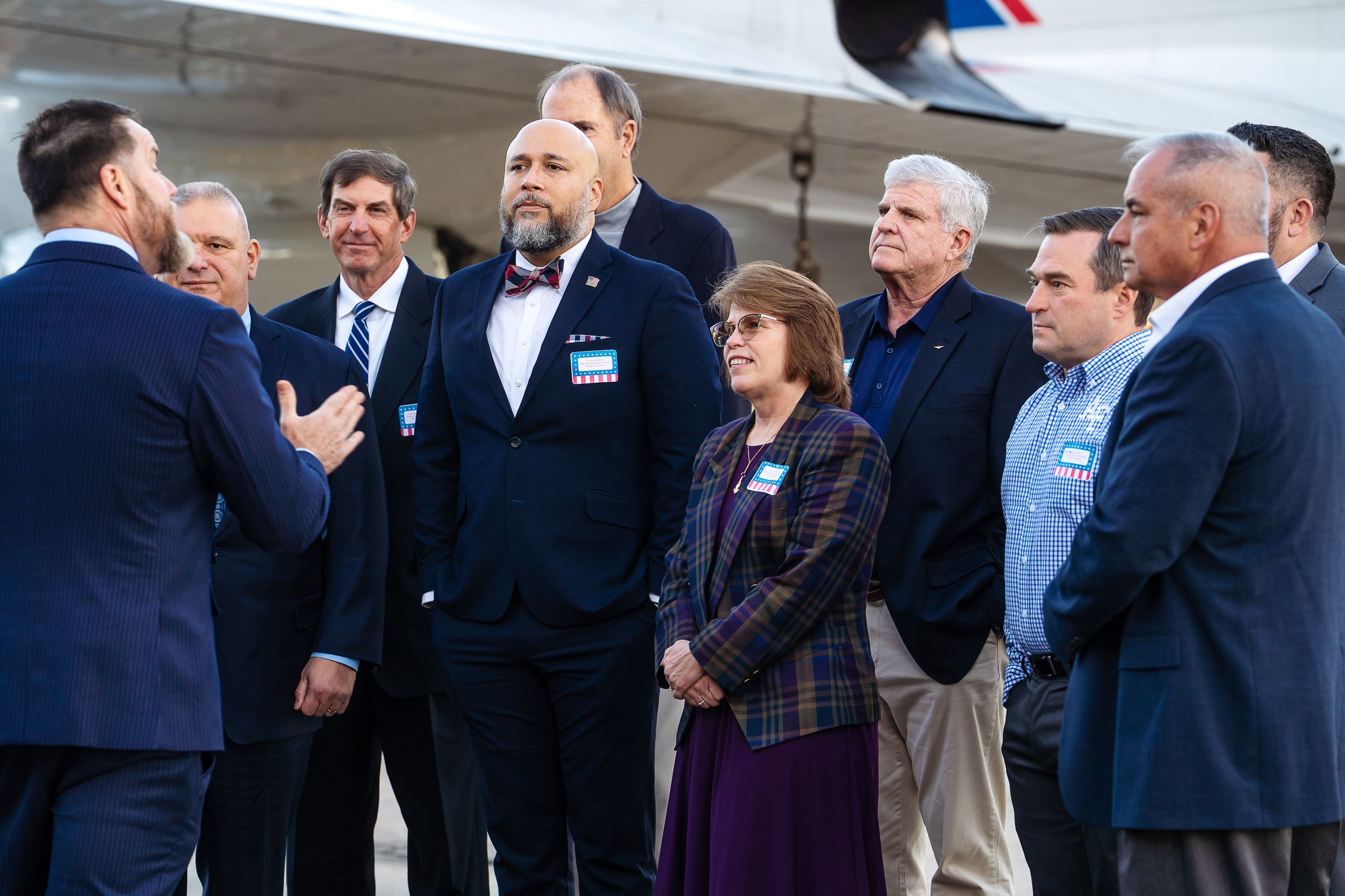 A group of professionals engaged in discussion at what appears to be a formal event.
