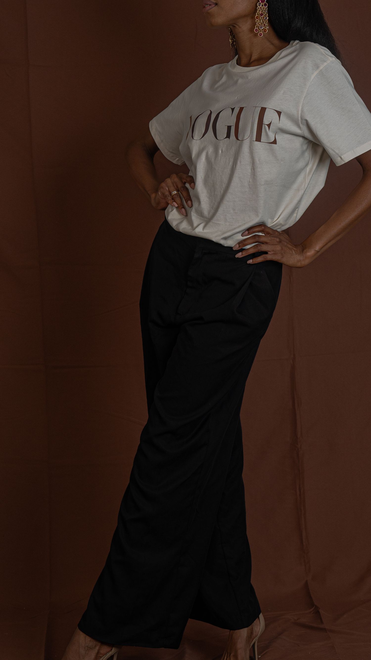 A minimalist fashion photo of a white Vogue t-shirt paired with a black maxi skirt.