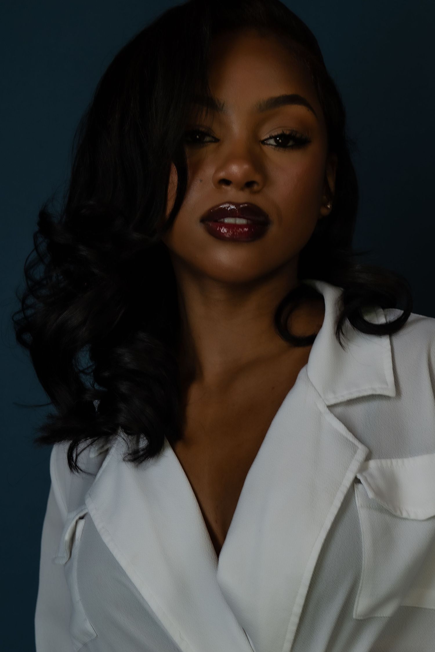 Portrait of a person in a white collared shirt against a dark background showing varying dramatic poses and expressions.