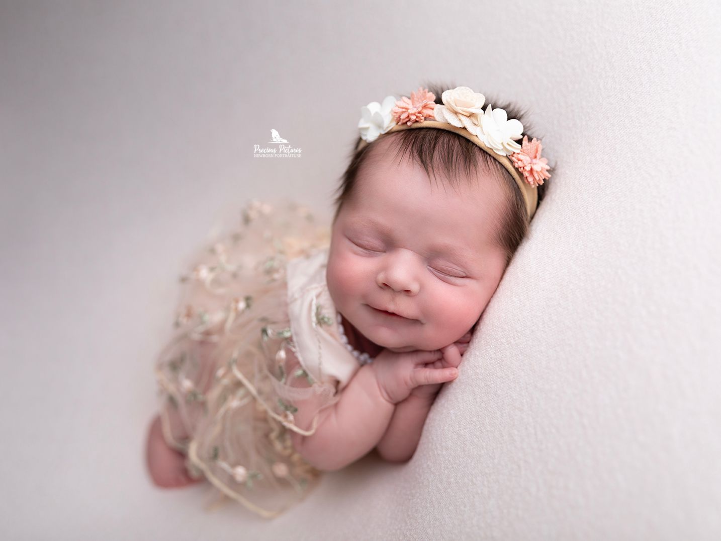 Sleeping newborn girl in a floral dress and cream flower headband, professional baby photography by Precious Pictures, Rabat, Malta