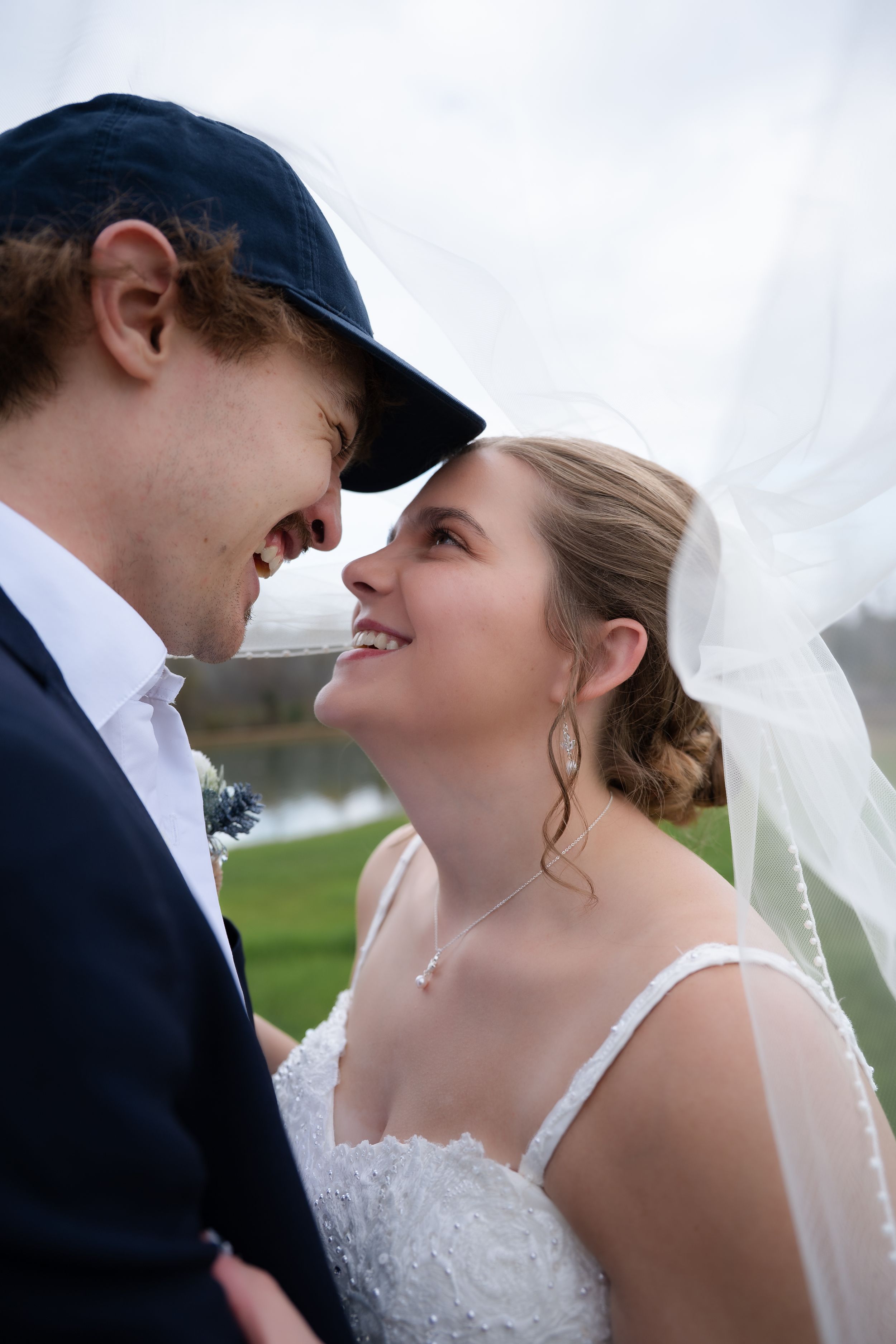 A romantic wedding sequence showing close-up shots of a bride and groom gazing lovingly at each other under a veil.