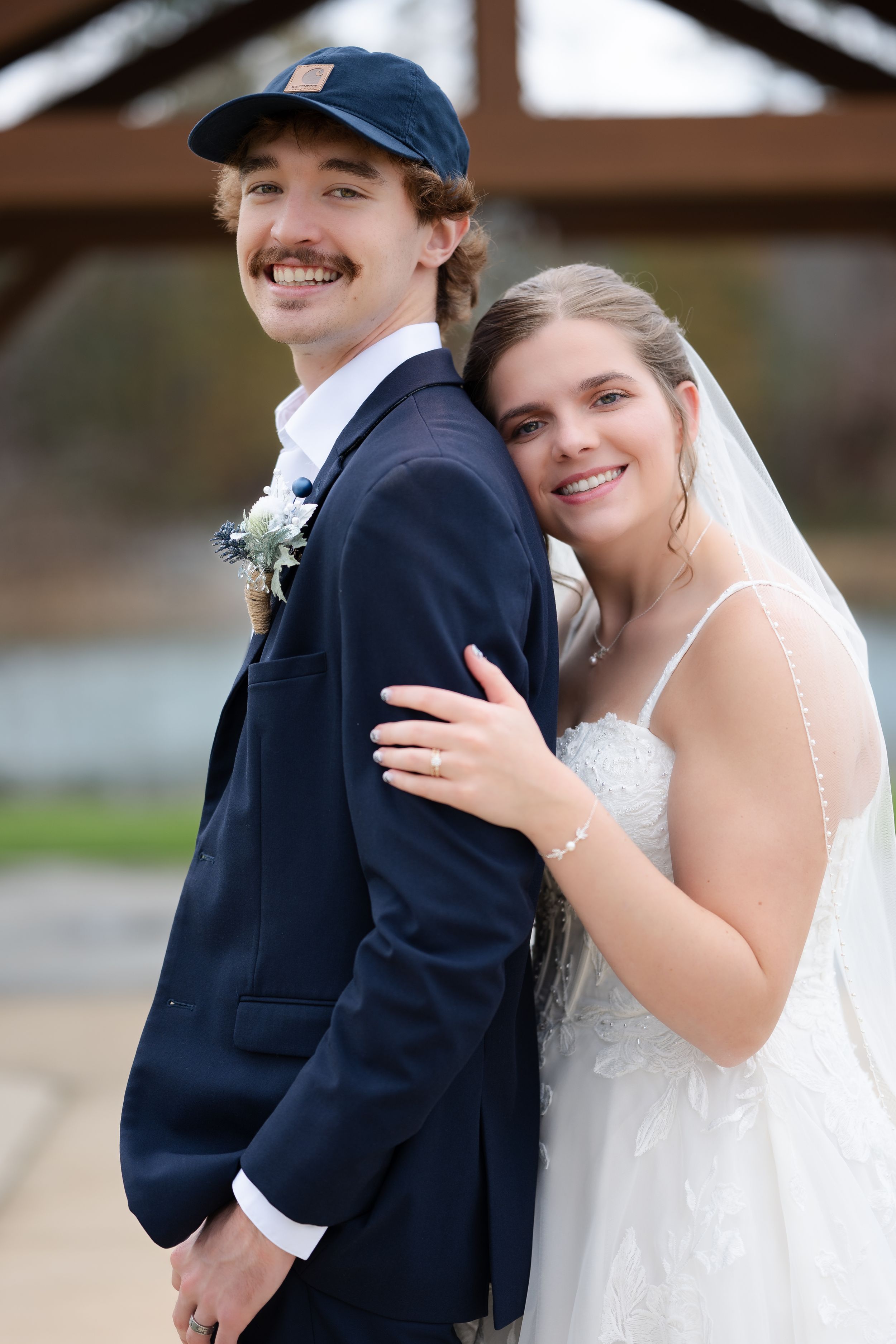 A bride and groom share a joyful moment together in a series of candid wedding photos showing their embrace and laughter.
