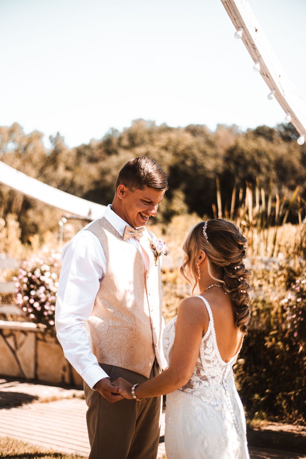 Couple sharing an intimate moment during outdoor wedding ceremony.